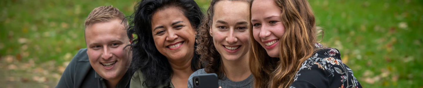 Vier collega’s poseren lachend voor een selfie
